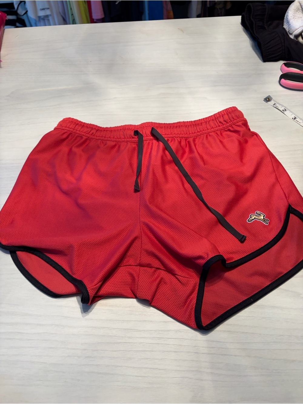 Tracksmith Van Cortlandt Red Athletic Mesh Shorts with Black Trim